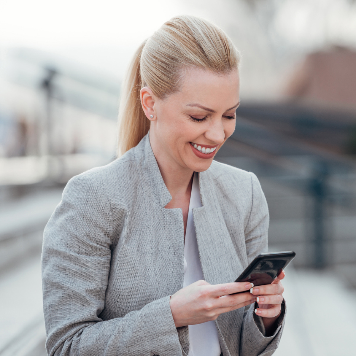 Professional with smartphone and laptop - Teams Copilot AI assistant for productivity